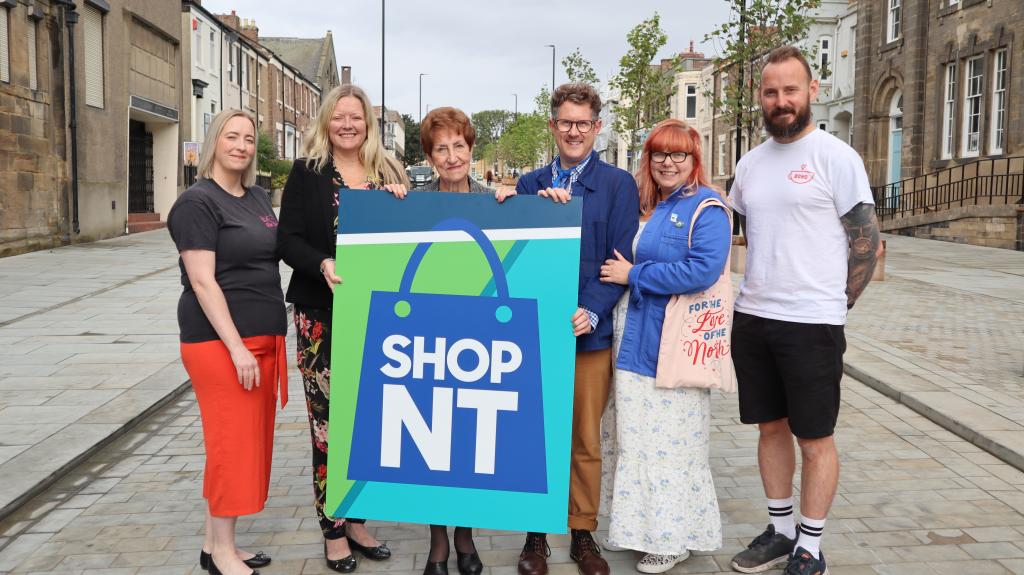 local business owners with elected mayor Norma Redfearn holding 'ShopNT' sign