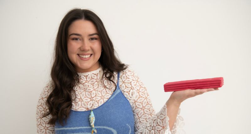 Globe Gallery - Artist Kitty McKay posing with Plasticine to be used for paintings, at Globe Gallery