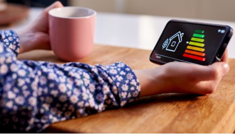 Someone holding an energy efficiency app